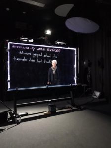 A woman standing behind a light board.