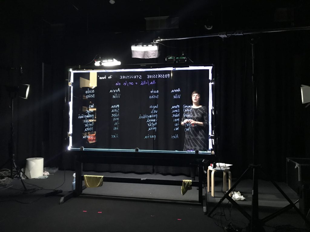 A woman standing behind a light board.